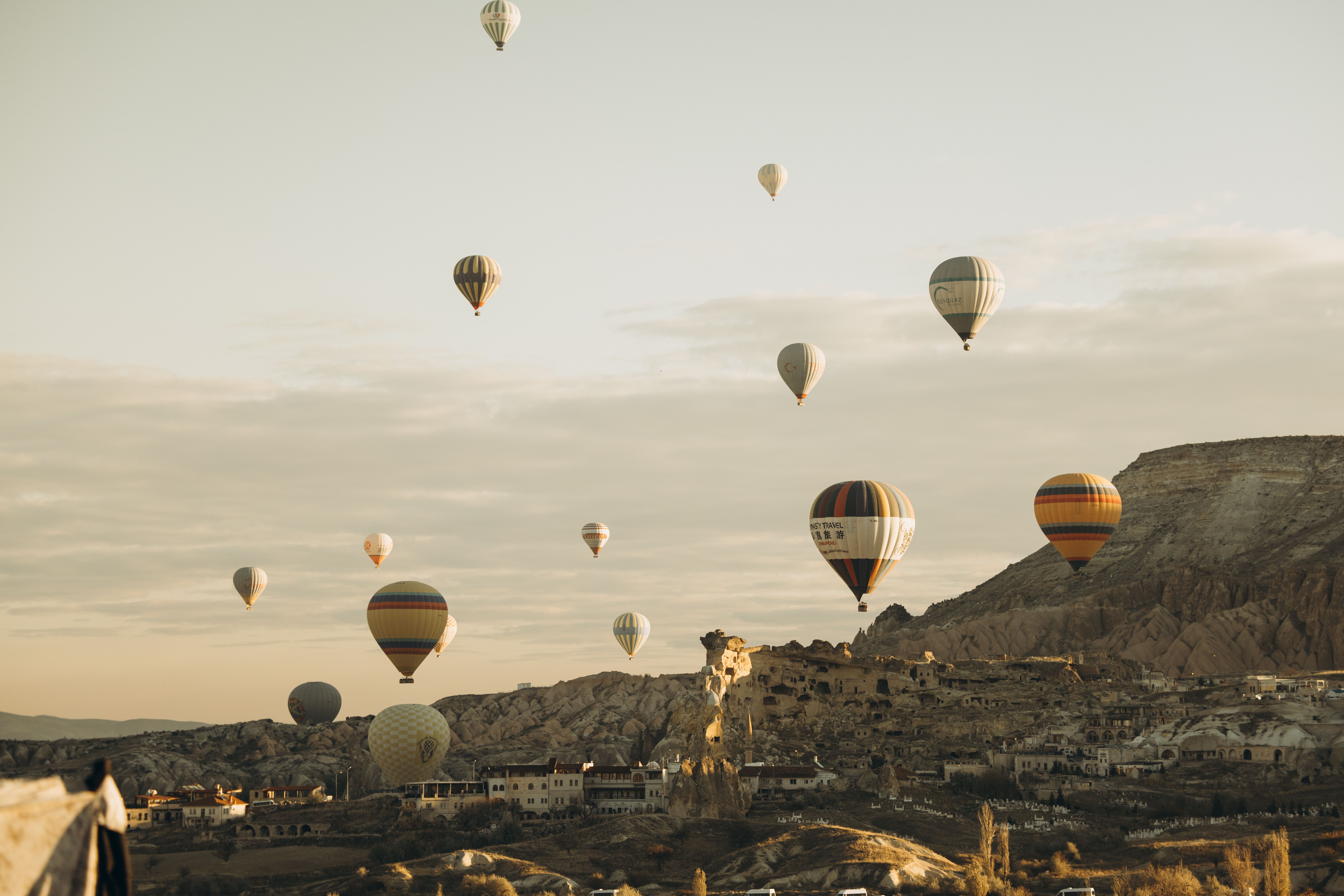 Hot air balloons flying over Cappadocia at sunrise