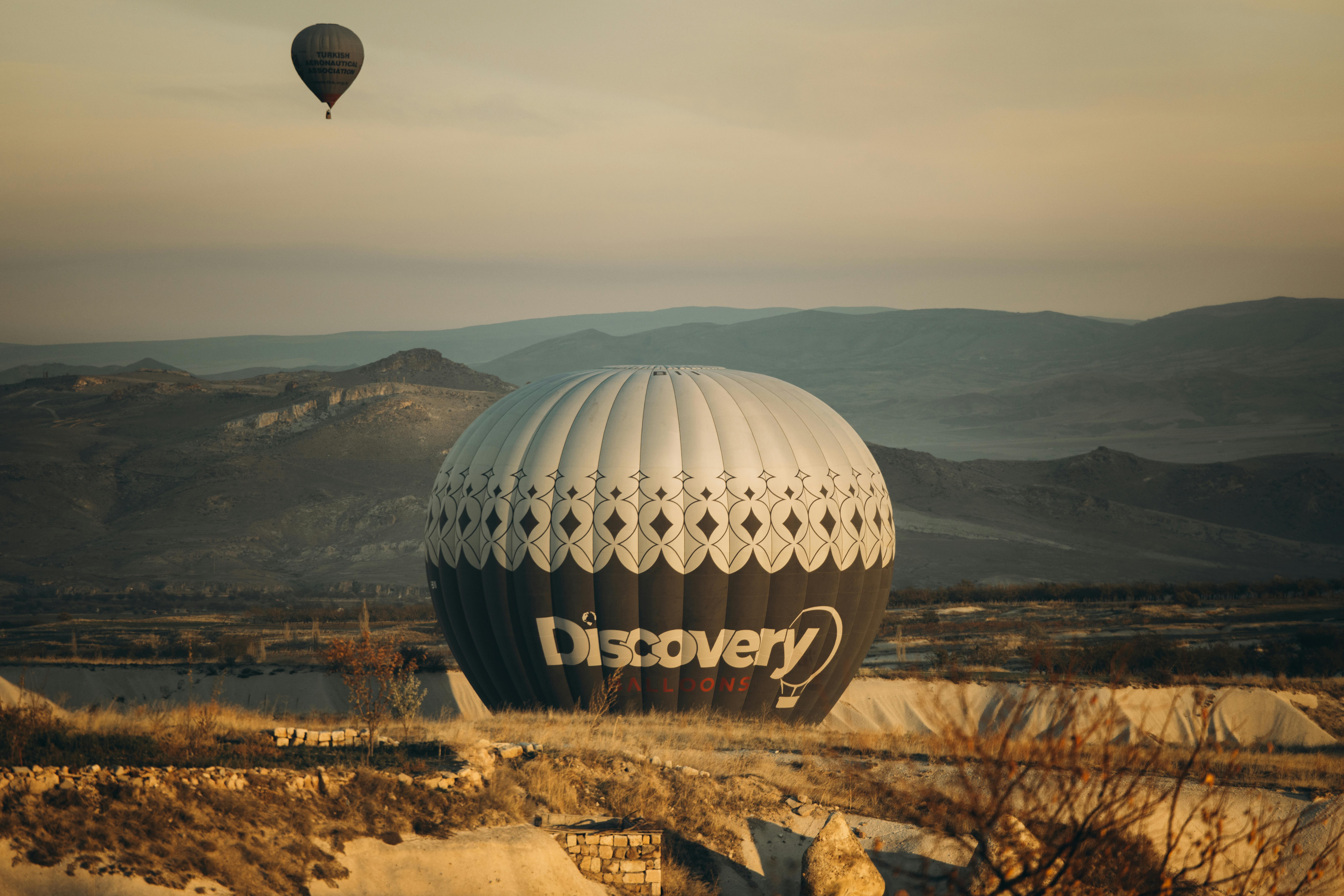 Captivating sunrise over Ürgüp, Türkiye with hot air balloons soaring above the landscape.