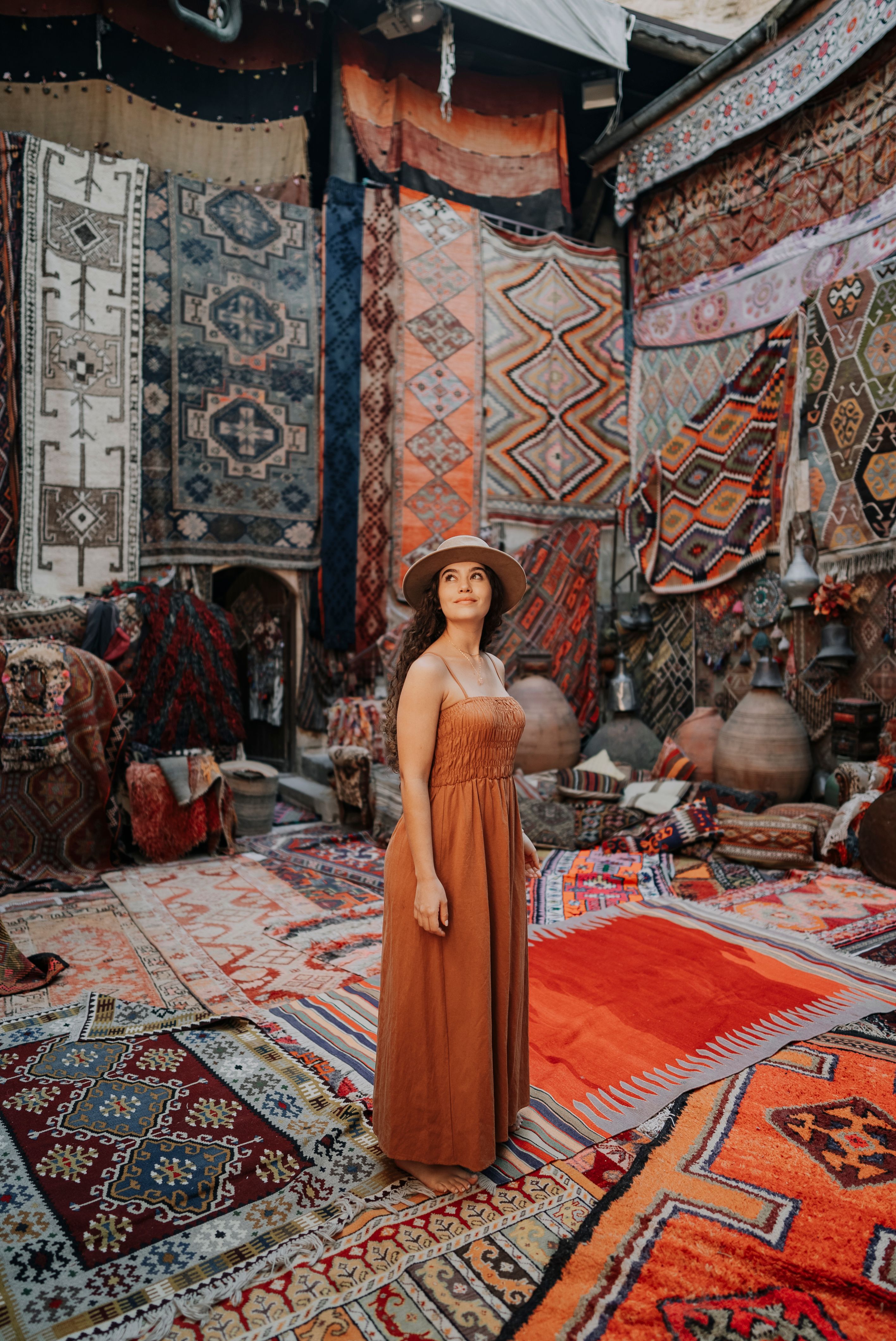 A woman standing in front of a rug · Free Stock Photo
