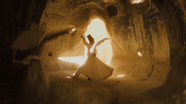 A whirling dervish dances in the mystical caves of Cappadocia, Türkiye.