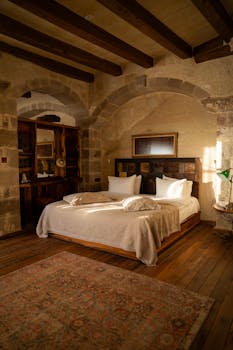 Warm and inviting luxury bedroom with stone walls in Ürgüp, Türkiye.