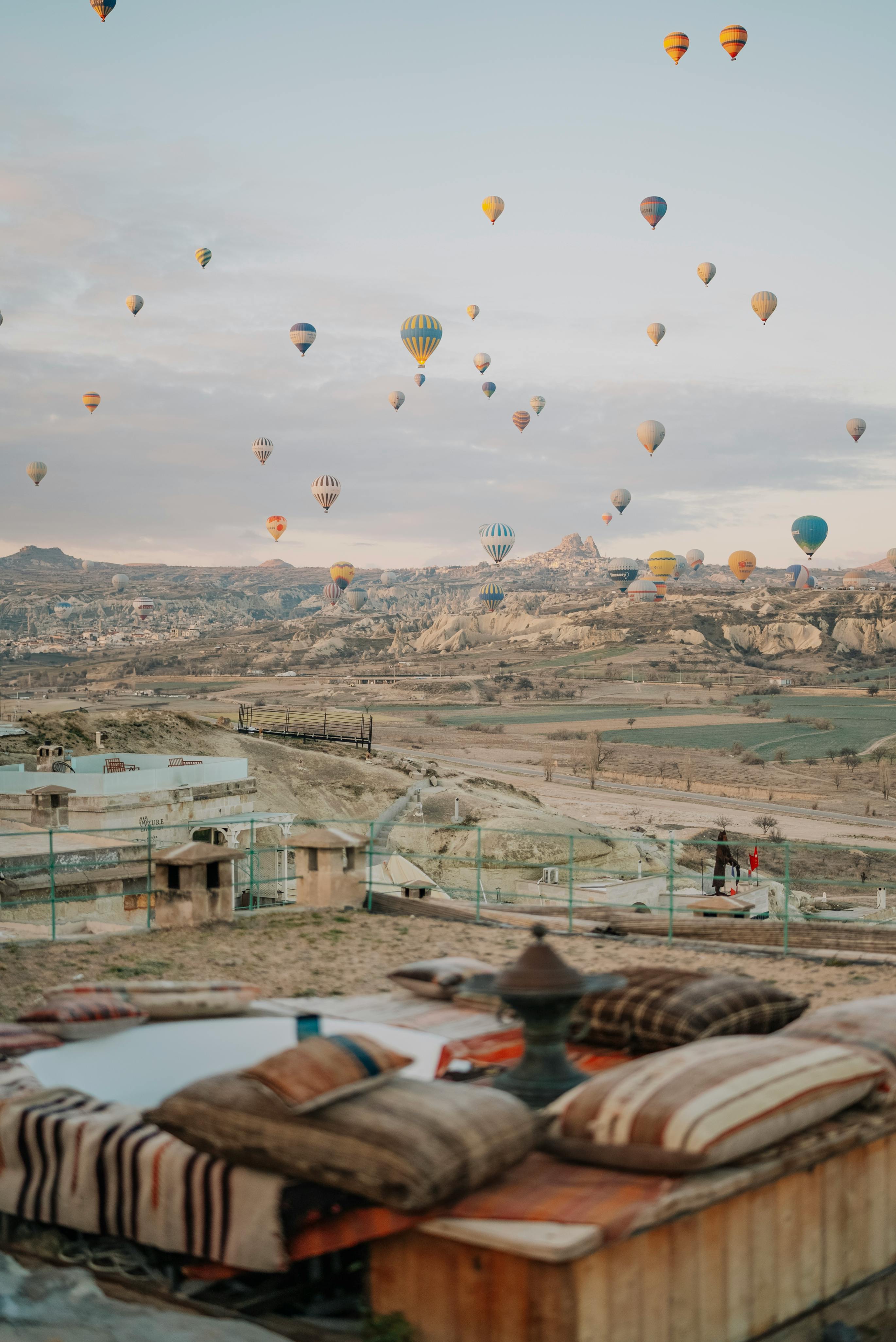 hot air balloons flying over the sky and a bed