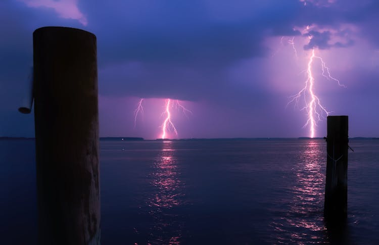 Lightning Over Sea Against Storm Clouds