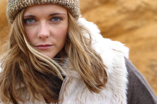 Portrait photography of a blonde haired woman wearing a  beanie hat