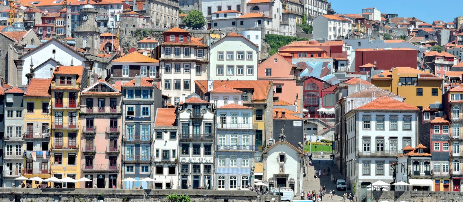 A vibrant view of the historic Ribeira District along the Douro River in Porto, Portugal. — flights from Funchal to Porto