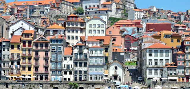 A vibrant view of the historic Ribeira District along the Douro River in Porto, Portugal.