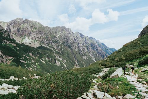 Free Beautiful view of a hiking trail in the Tatra Mountains with lush greenery and rocky slopes. Perfect for travel enthusiasts. Stock Photo