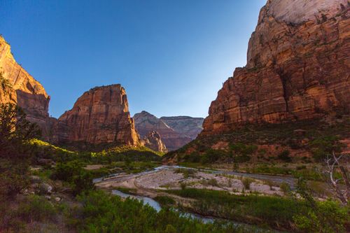 Free Scenic landscape of Zion National Park with towering canyons and a winding river. Stock Photo