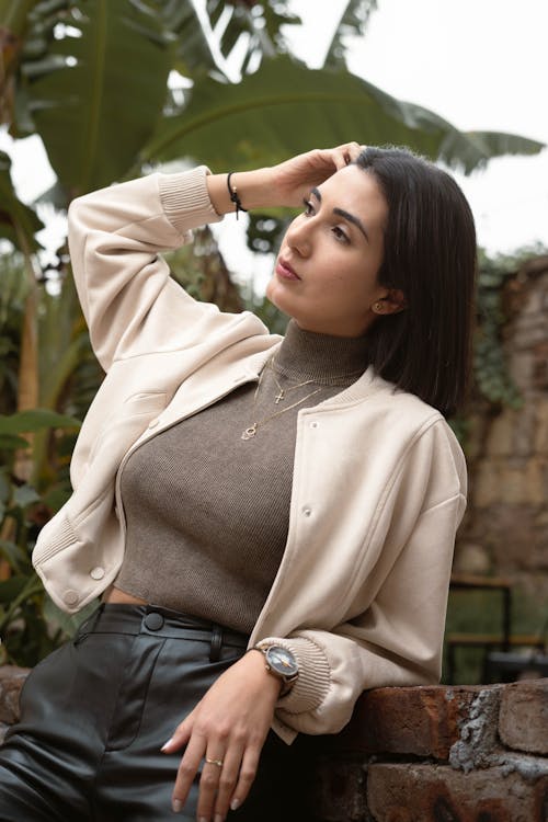 A woman in leather pants and a jacket posing for the camera