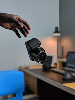 Levitation effect of a camera in a stylish office, capturing creativity and innovation.