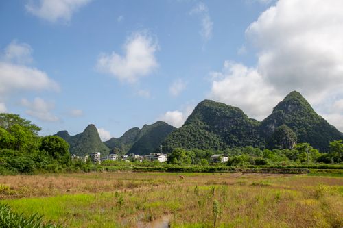 Free Picturesque rural landscape with Karst mountains and a small village under a blue sky. Stock Photo