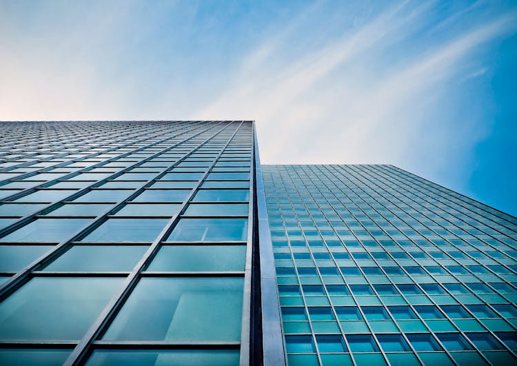 Low Angle View Of Office Building Against Blue Sky