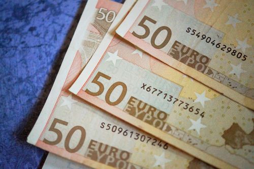 Free Stack of 50 Euro notes arranged on a textured surface, emphasizing European currency. Stock Photo