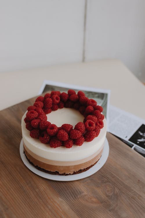 A chocolate cake with raspberries on top