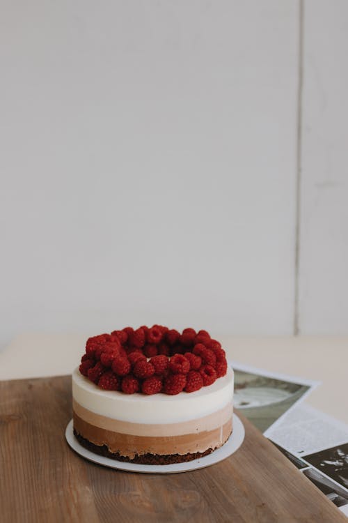 A chocolate cake with raspberries on top