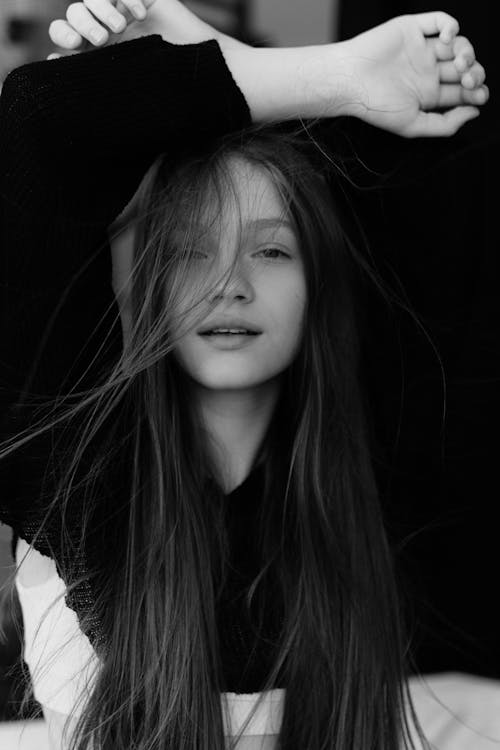 A black and white photo of a girl with long hair