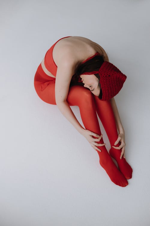 A woman in red tights and a hat