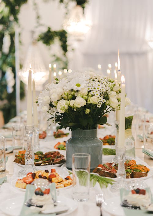 A table with white plates and flowers on it