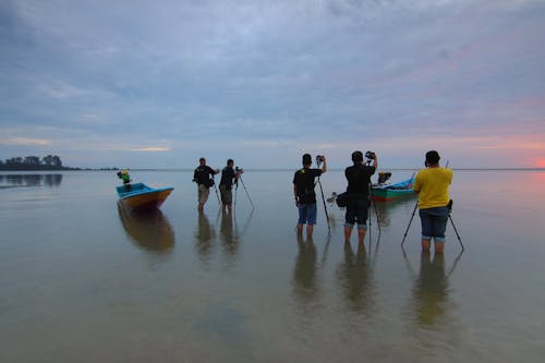 People on Beach Against Sky