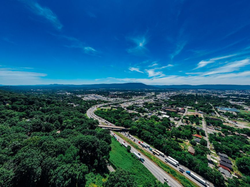 Stunning Ridge Runner Smoky Mountain Helicopter Tour Review: An Unforgettable Tennessee Adventure Review 2026 - Explore the vibrant aerial view of Chattanooga with lush greenery and bustling highways on a sunny day.