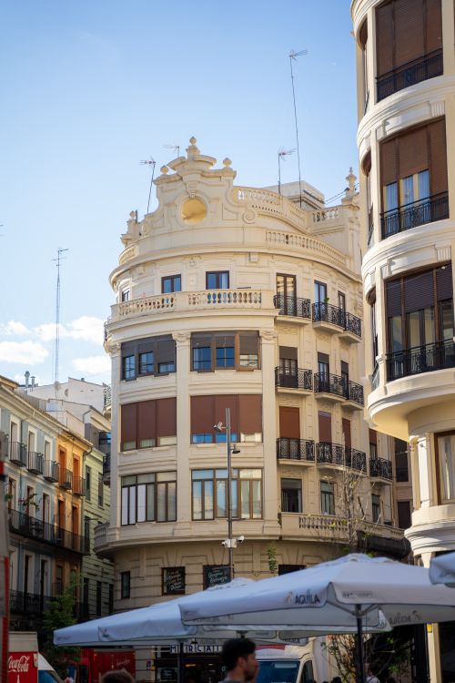 Free A detailed view of a historic building facade in downtown Valencia, Spain, under a clear blue sky. Stock Photo