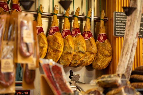 A display of cured meats hanging on a rack