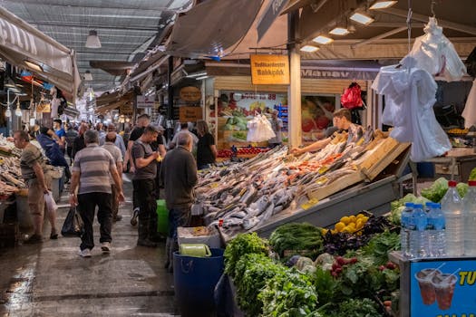 A bustling fish market in İzmir with fresh produce and shoppers exploring the stalls.