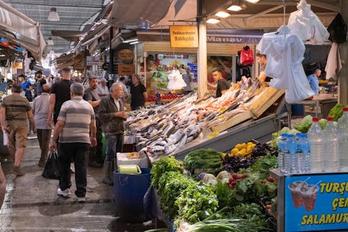 A market with people walking around and shopping