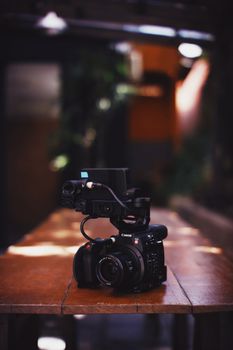 High-quality camera setup on a wooden table, capturing an indoor environment.