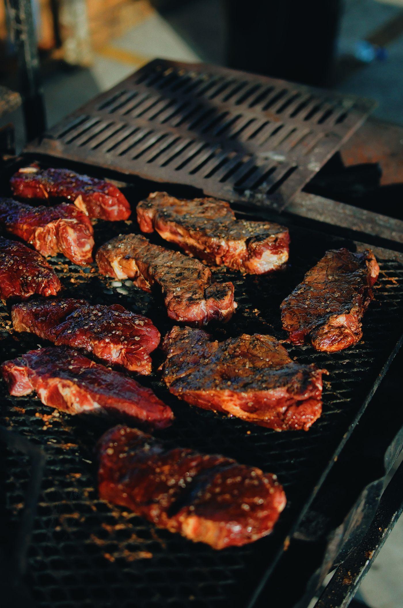 Sizzling steaks on a charcoal grill