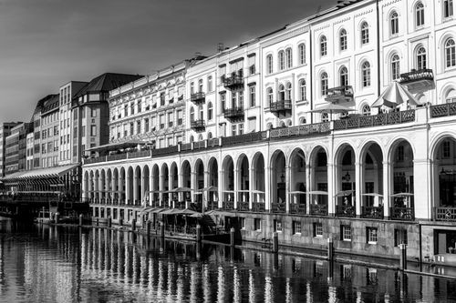 Free Black and white photo of arched buildings along a canal in Hamburg, Germany. Stock Photo