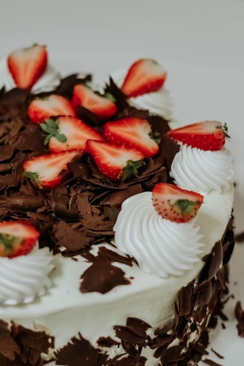 A chocolate cake with strawberries and chocolate frosting
