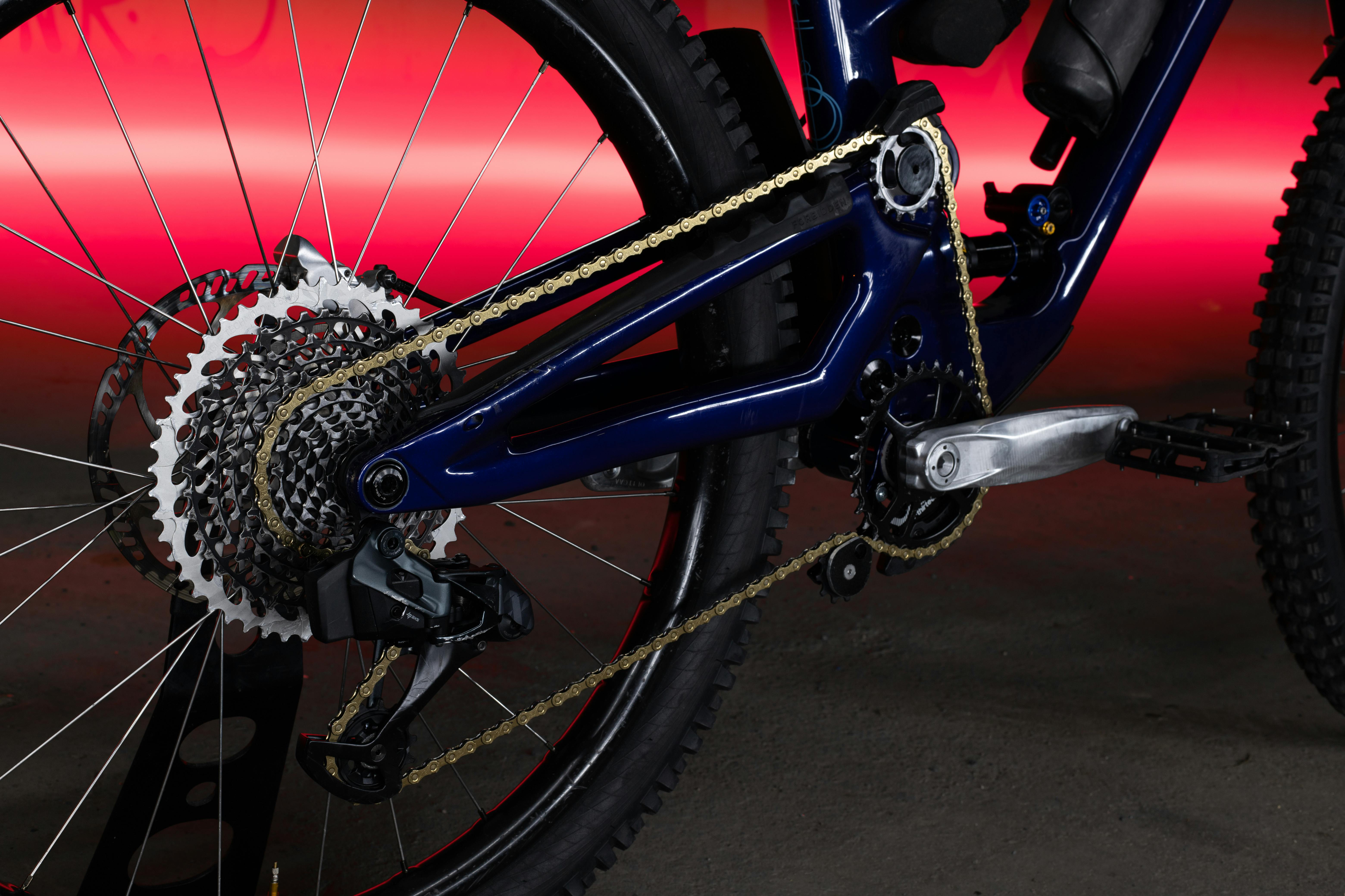 Detailed view of a mountain bike gear set against a dramatic red background.