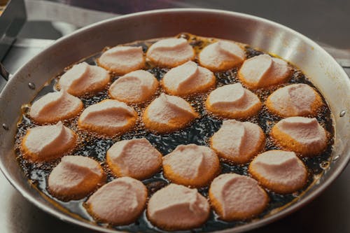 A pan filled with fried dough and sugar