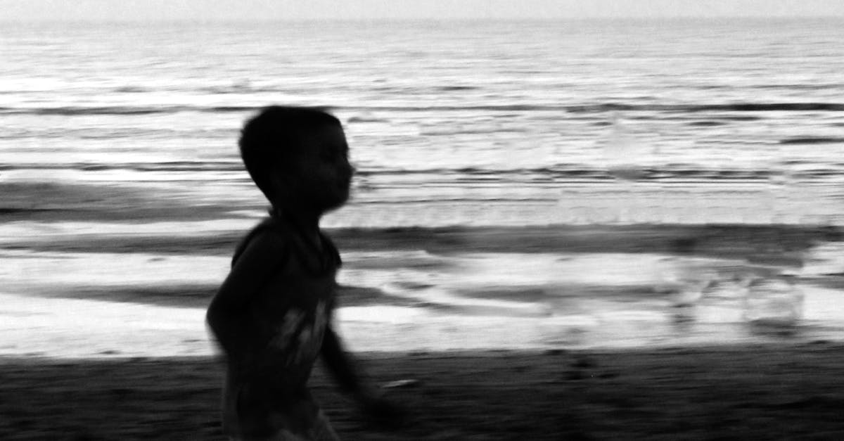 Boy Playing on Beach Against Sky