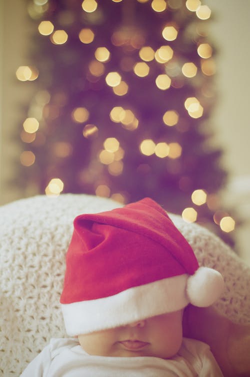 Free Close-up of Illuminated Christmas Tree And A Baby Stock Photo