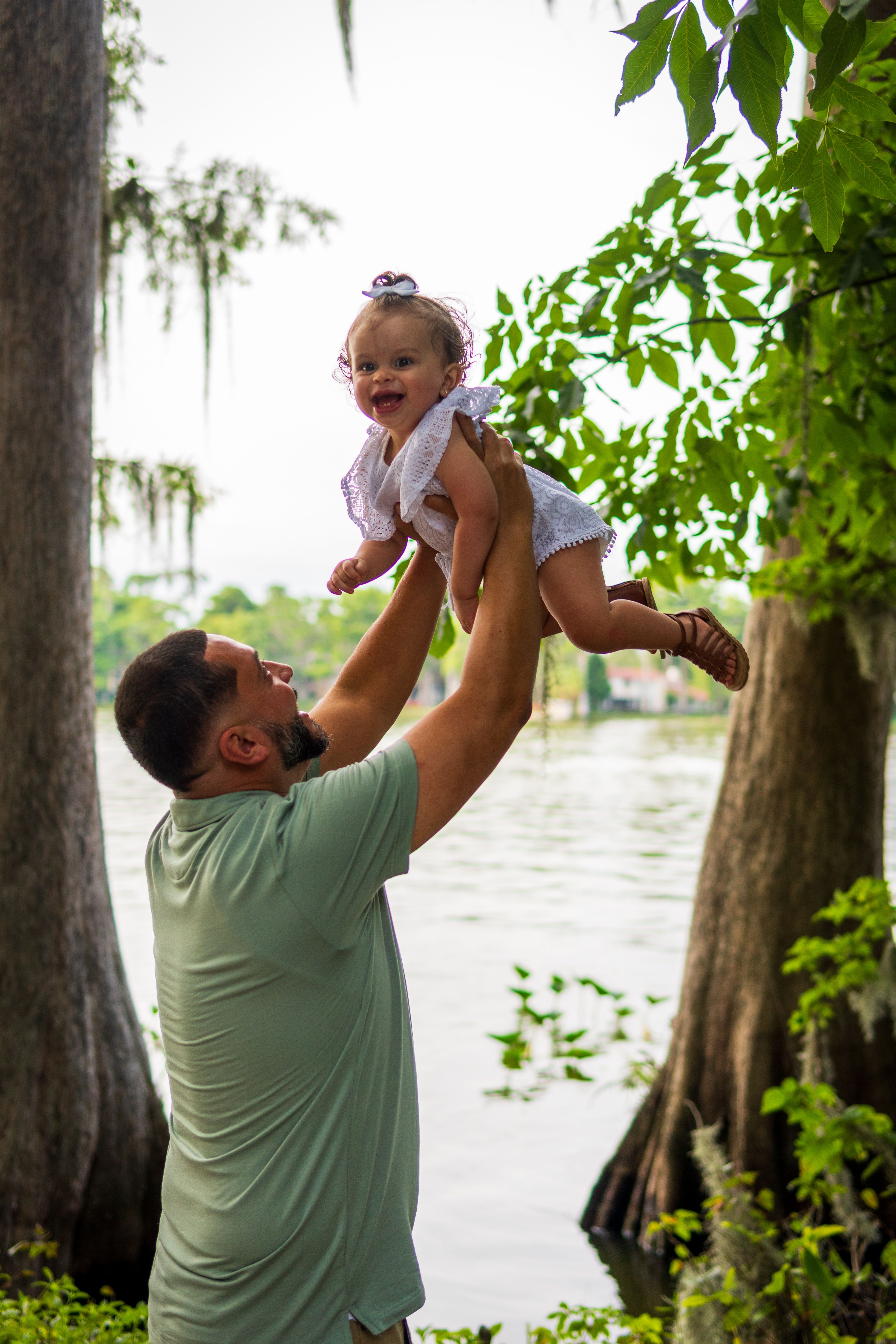 Smiling Man Carrying Baby on His Neck · Free Stock Photo