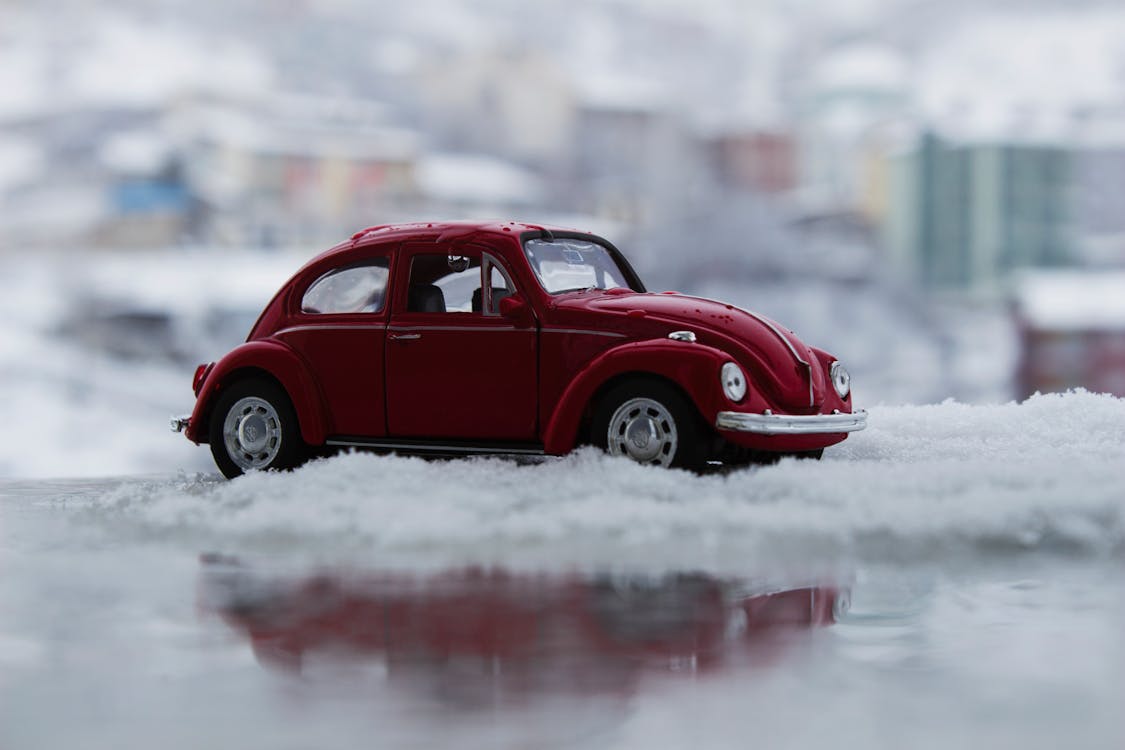 Free Красный игрушечный автомобиль в снегу Stock Photo