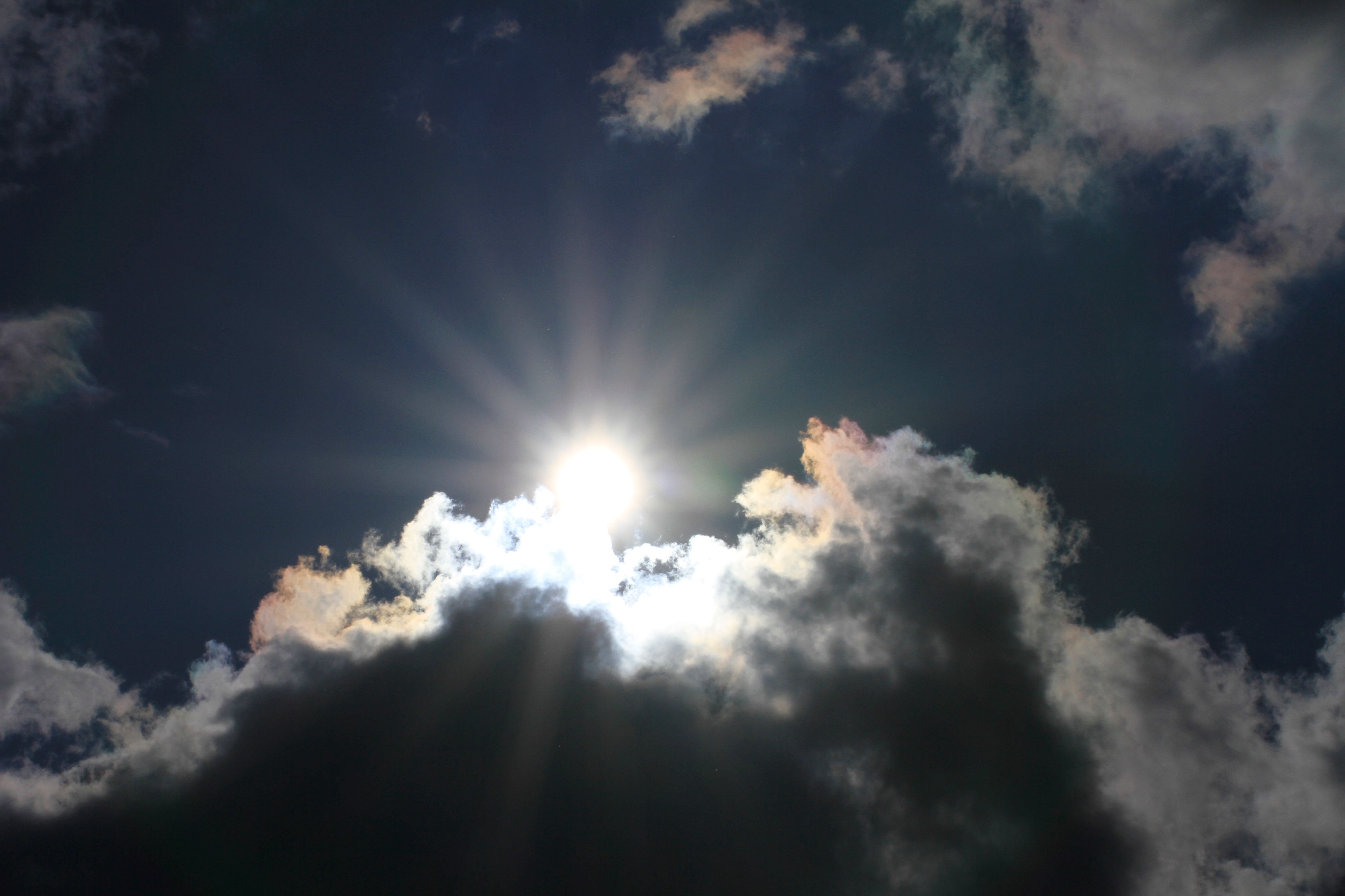 Low Angle View Of Sun Shining Through Clouds Free Stock Photo