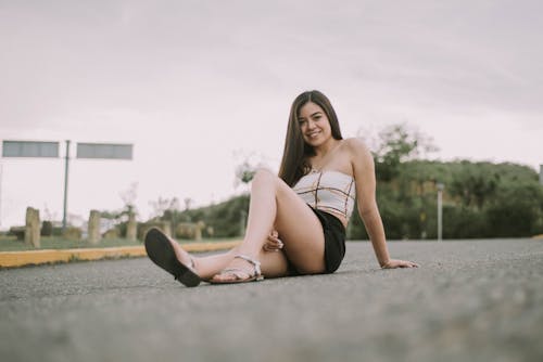 Woman Sitting On Road