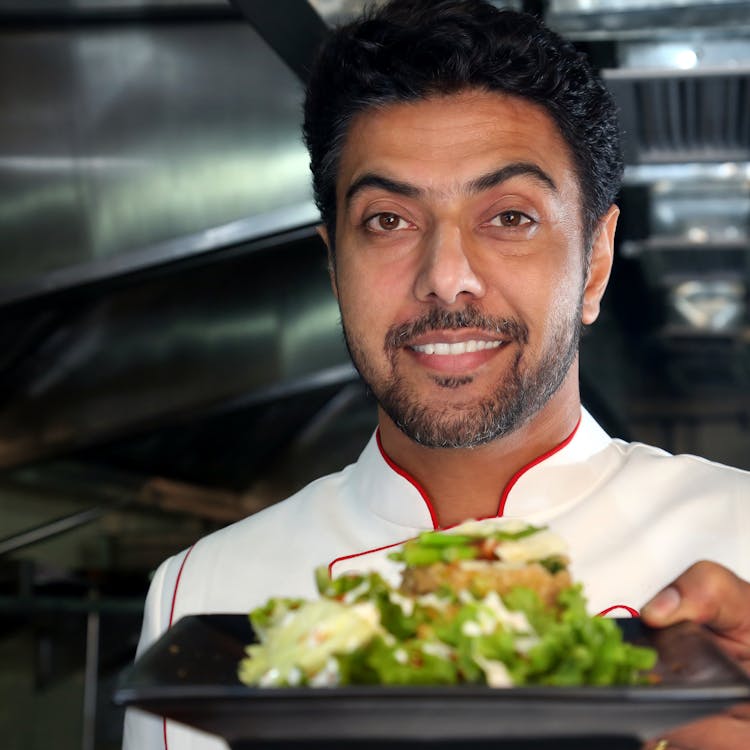 Chef Holding A Salad On Plate · Free Stock Photo