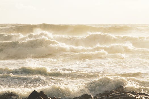 Captivating ocean waves crashing against rocks at Porto's scenic coastline.