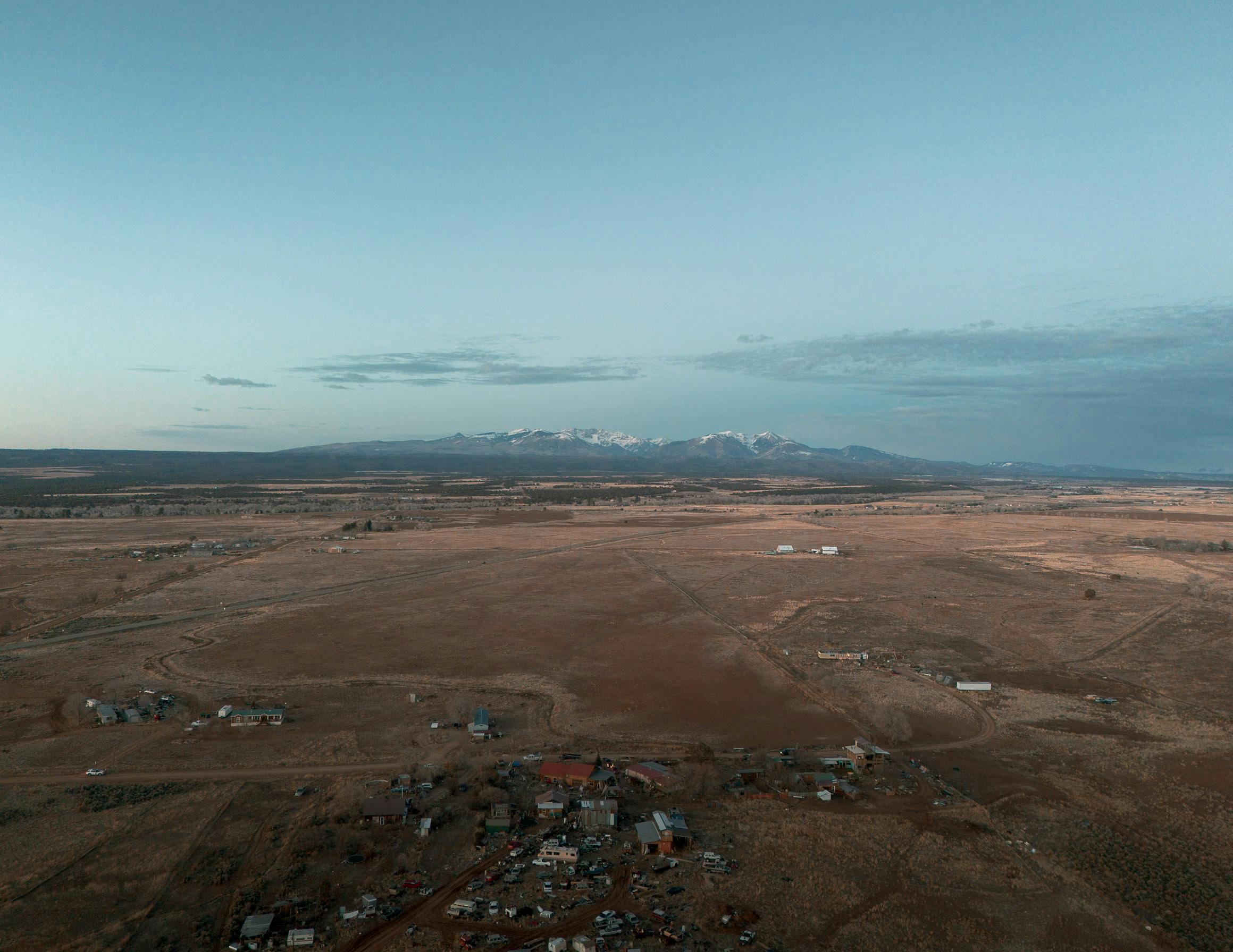 an aerial view of a small town and mountains