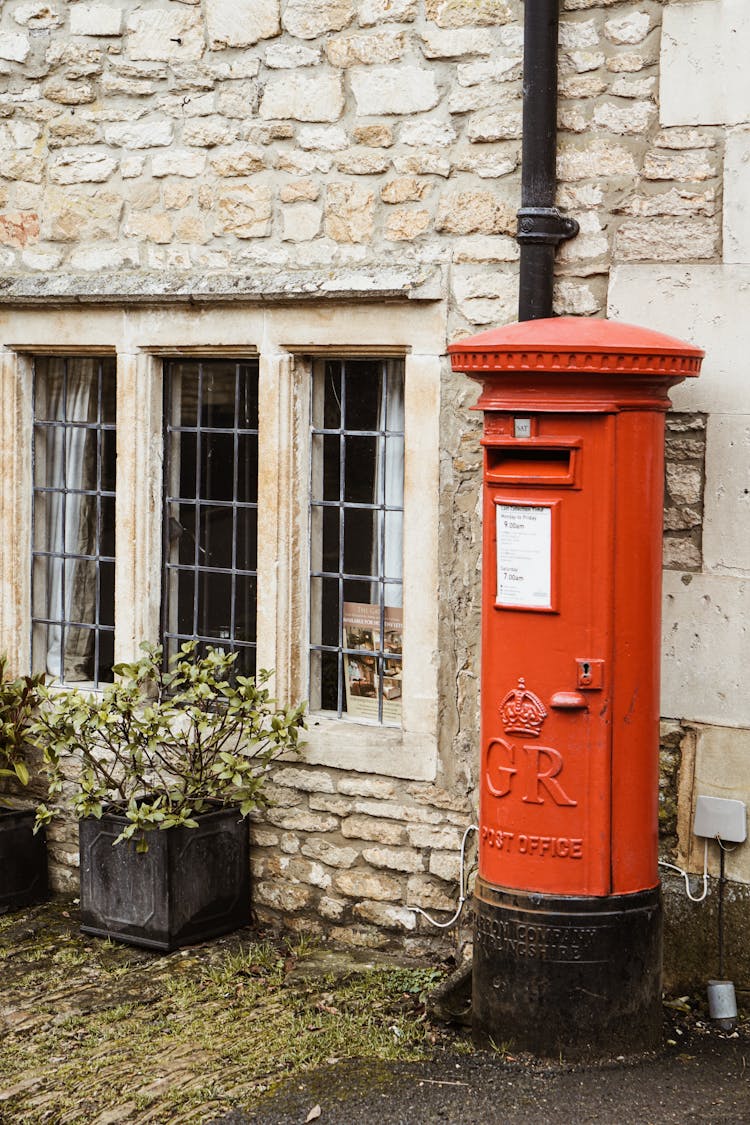 Red Mailbox Beside Window