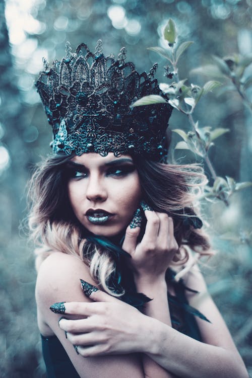 Women Wearing a Black Crown Close-up Photography