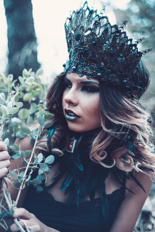 Woman Wearing Black Lace Crown Beside Green Leaves