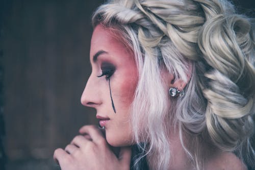 Free Woman With Smudged Black Eyeliner Facing to the Side Stock Photo