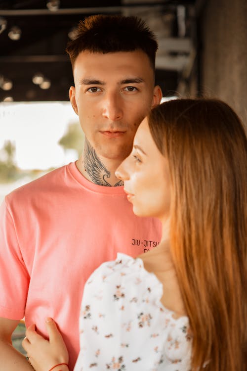 A man and woman in pink shirts standing next to each other