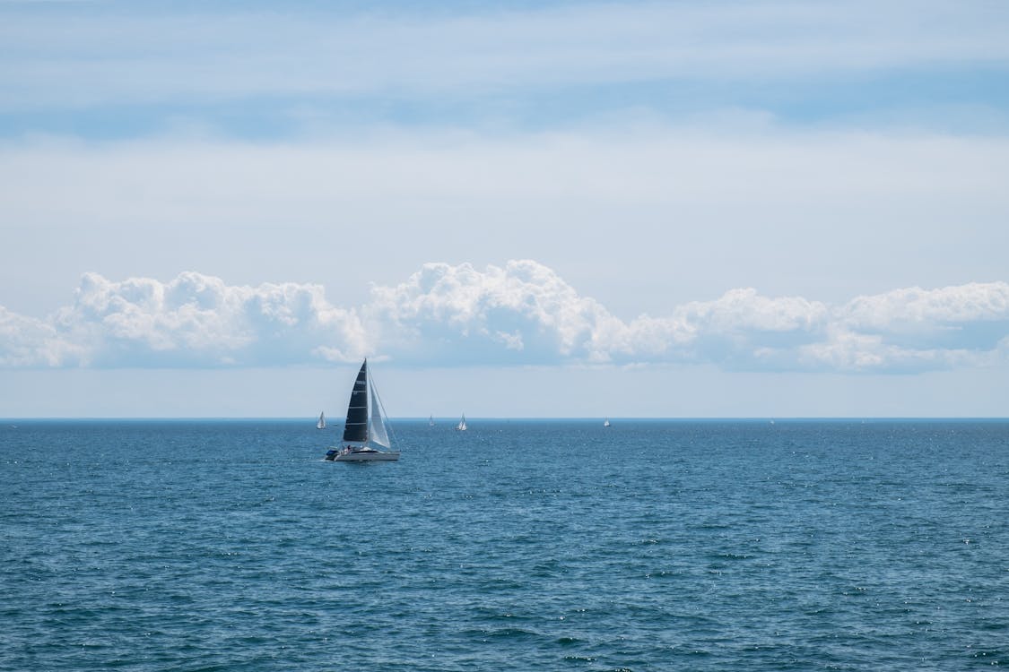 Sailboat Sailing on Sea Against Sky