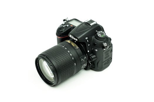 Close-up image of a Nikon DSLR camera with lens on a white background, ideal for photography enthusiasts.